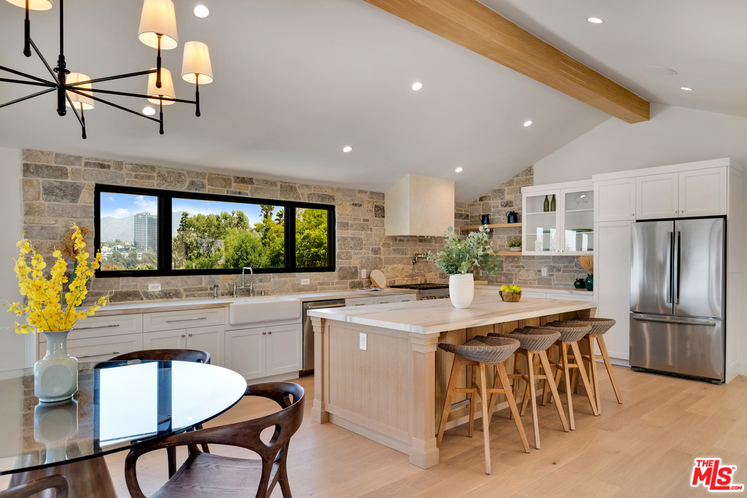 3614 Willowcrest Avenue Studio City, CA 91604 - Photo 13 of 43 a kitchen with stainless steel appliances granite countertop table chairs sink and cabinets