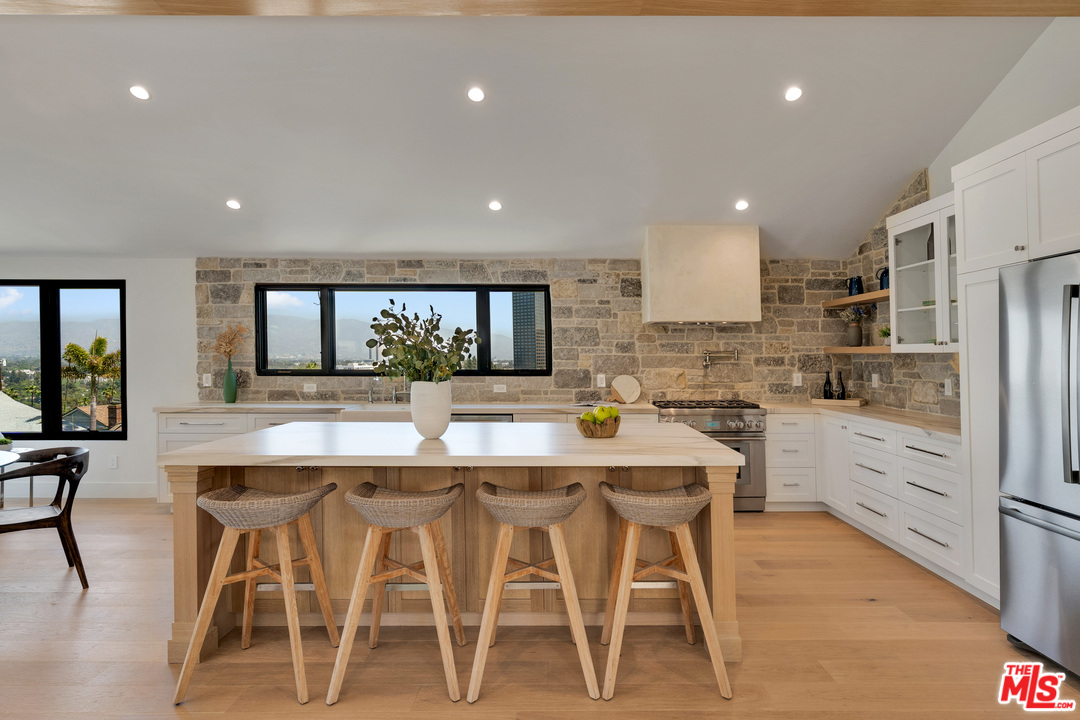 3614 Willowcrest Avenue Studio City, CA 91604 - Photo 14 of 43 a kitchen with appliances cabinets and chair