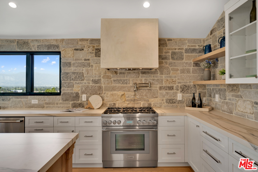 3614 Willowcrest Avenue Studio City, CA 91604 - Photo 16 of 43 a kitchen with stainless steel appliances a stove and a sink