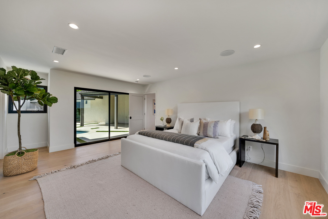 3614 Willowcrest Avenue Studio City, CA 91604 - Photo 23 of 43 a large bedroom with a bed and a large window