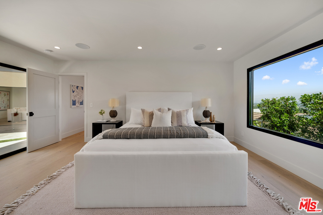 3614 Willowcrest Avenue Studio City, CA 91604 - Photo 24 of 43 a bedroom with bed and a large window