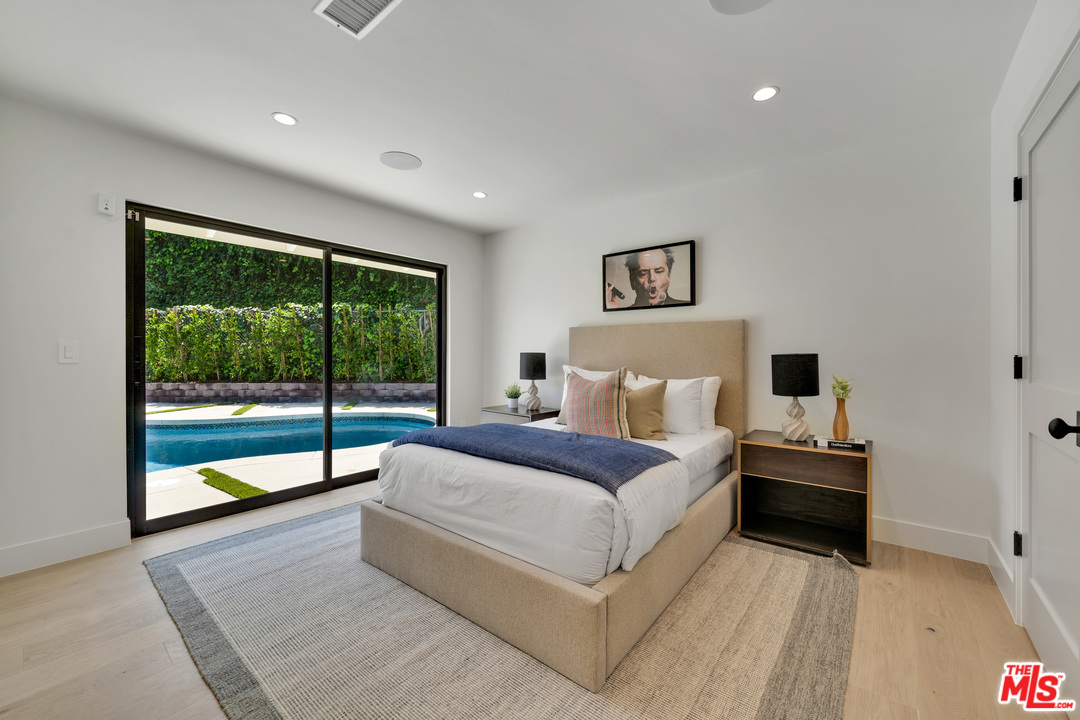 3614 Willowcrest Avenue Studio City, CA 91604 - Photo 30 of 43 a spacious bedroom with a large bed and a large window