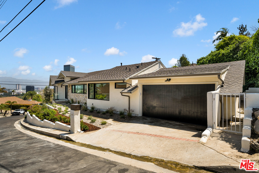 3614 Willowcrest Avenue Studio City, CA 91604 - Photo 4 of 43 a front view of a house with a yard and garage