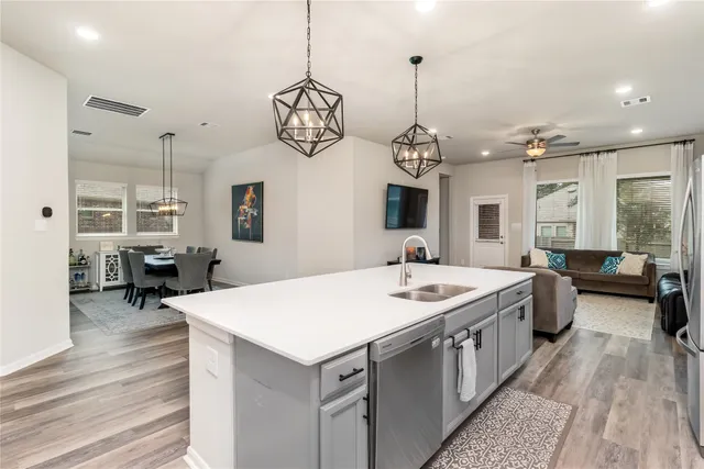 a large kitchen with a table and chairs
