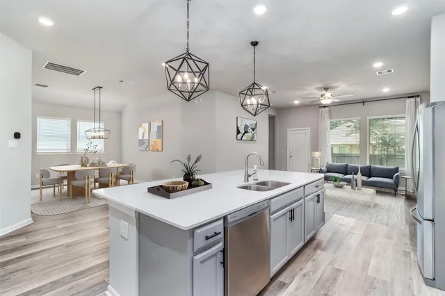 an open kitchen with a table and chairs
