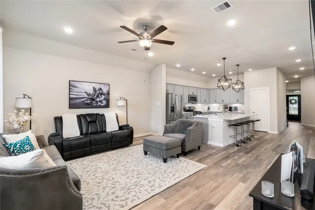 a living room with furniture and kitchen view