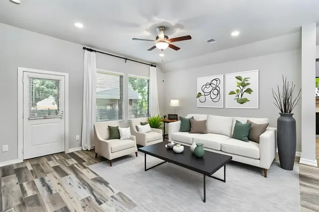 a living room with furniture and large windows