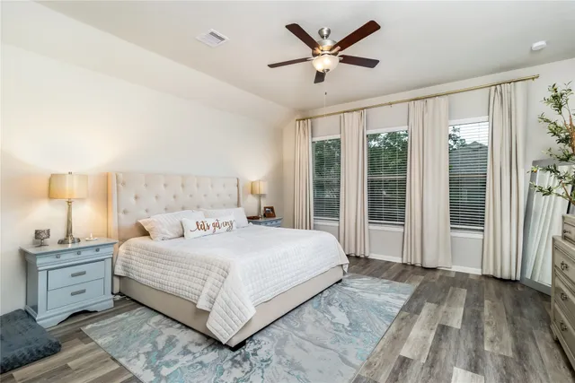 a bedroom with a large bed and a large window
