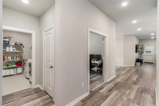 a view of a hallway view with wooden floor and closet