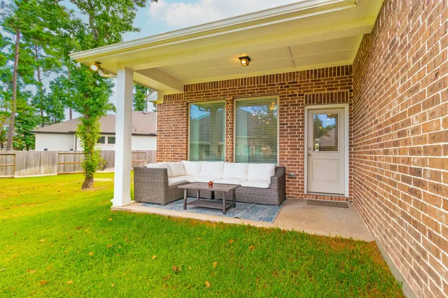 a view of an house with backyard porch and sitting area