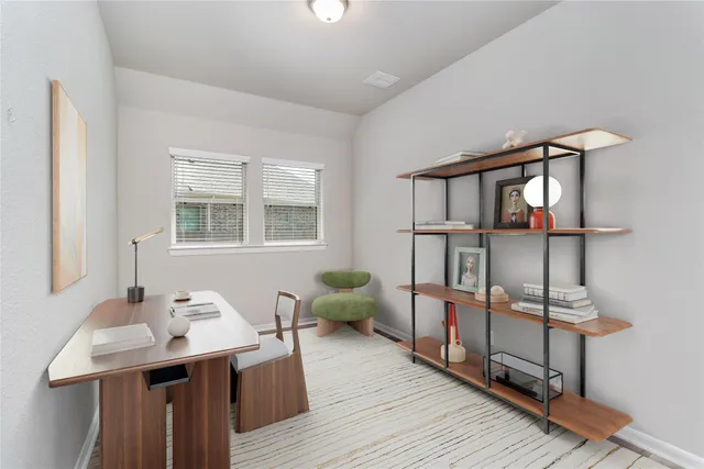 a view of a workspace with furniture and a wooden floor