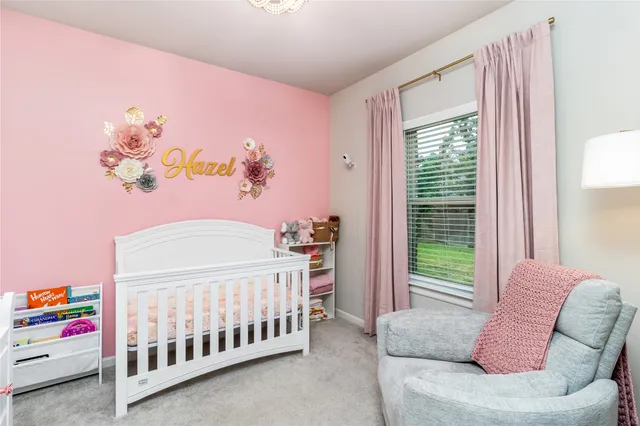 a bedroom with furniture and a large window