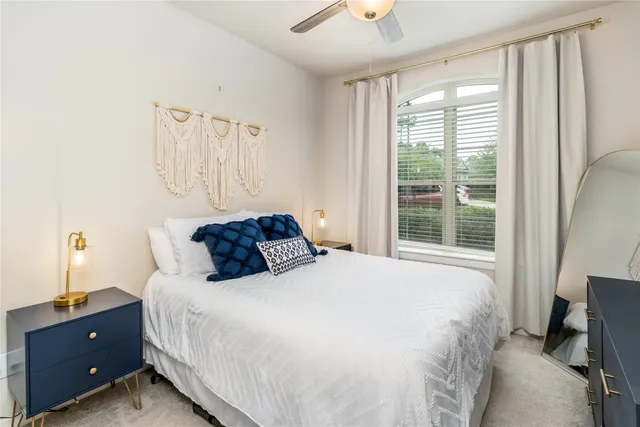 a bedroom with a bed and window