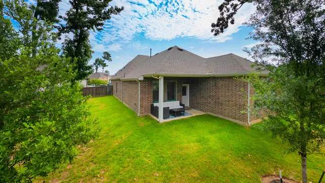 a view of a house with a yard porch and sitting area