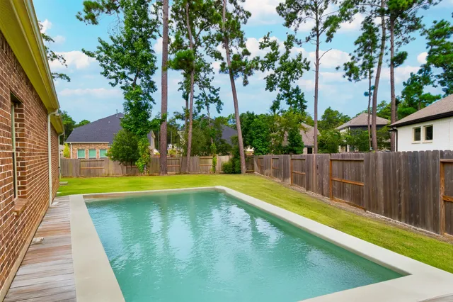 a view of swimming pool with a small yard