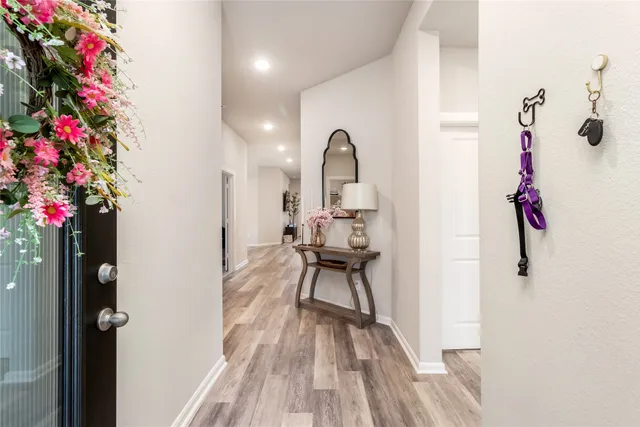 a view of a bathroom with a sink and wooden floor