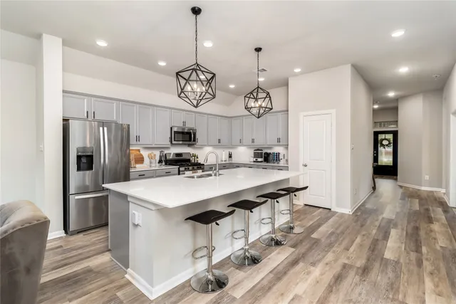 a kitchen with stainless steel appliances a sink stove and refrigerator