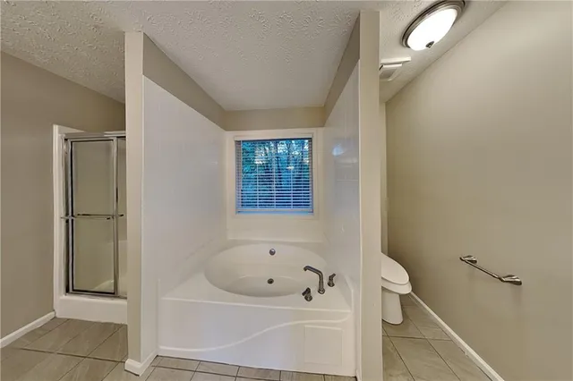 a bathroom with a bathtub and shower