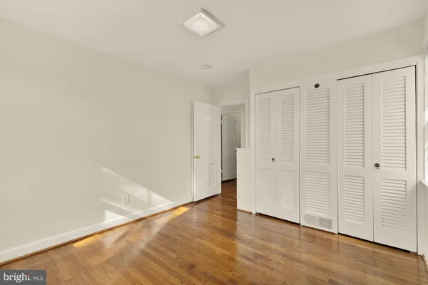 a view of a room with wooden floor
