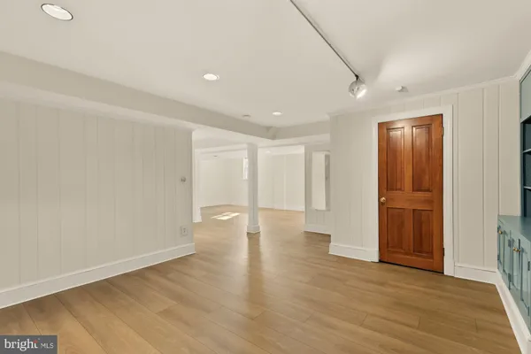 a view of empty room with wooden floor