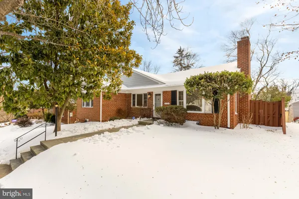 a view of a house with a snow in the yard