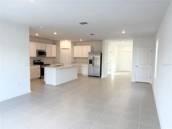 a view of a kitchen with refrigerator and microwave
