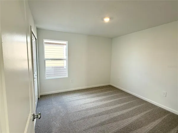 an empty room with a empty space and windows