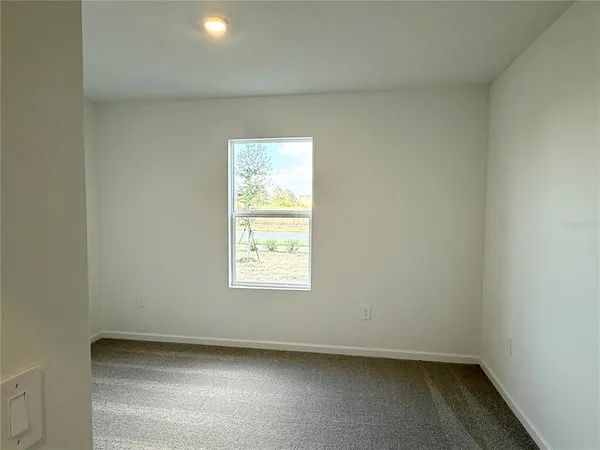 a view of an empty room and a window
