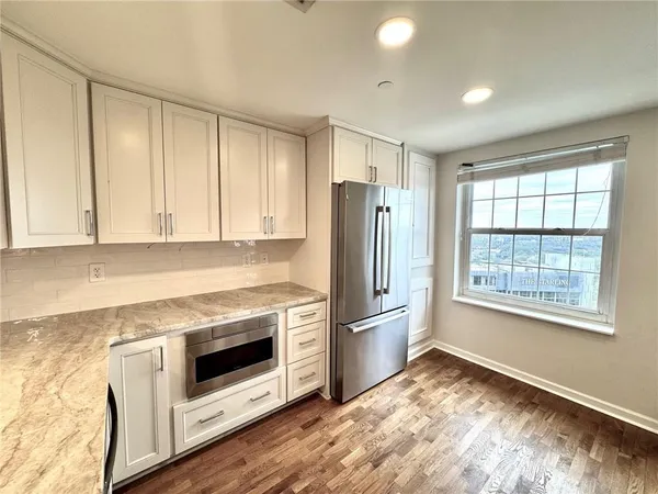 a kitchen with a refrigerator and window