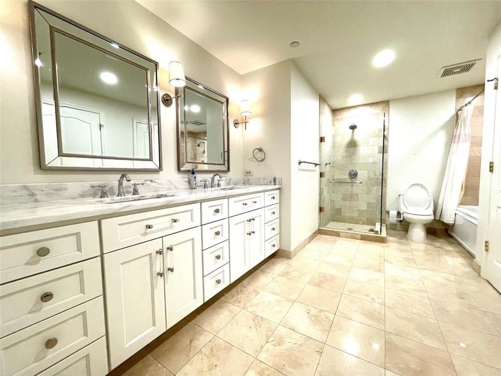 195 14th Street Northeast, Unit P603 Atlanta, GA 30309 - Photo 14 of 27 a spacious bathroom with a double vanity sink a mirror and a shower