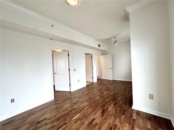 a view of empty room with wooden floor