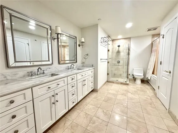 a bathroom with a granite countertop sink mirror and a