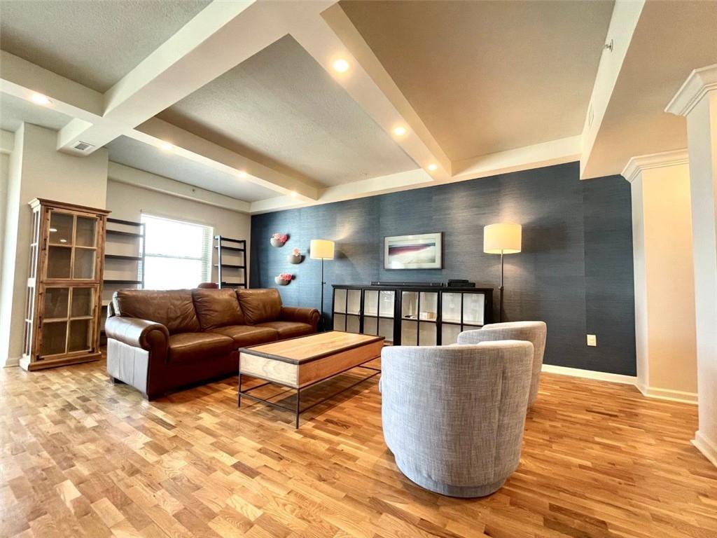 195 14th Street Northeast, Unit P603 Atlanta, GA 30309 - Photo 2 of 27 a living room with furniture and a wooden floor