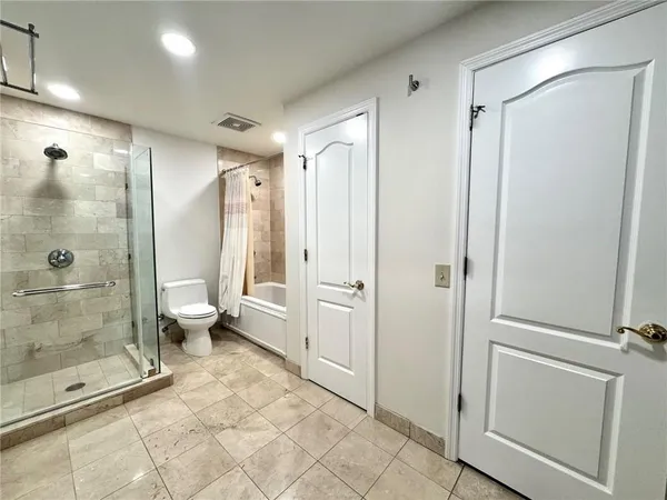a bathroom with a shower and a glass door