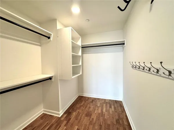 a view of a room with wooden floor and white walls