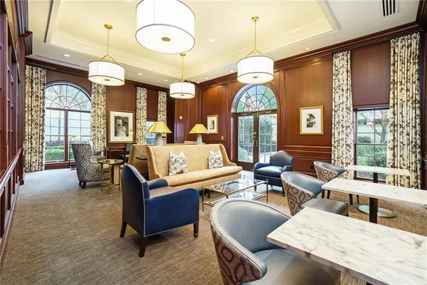a living room with fireplace furniture and a large window