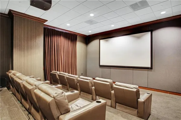 a media room with lots of chairs and a projector screen