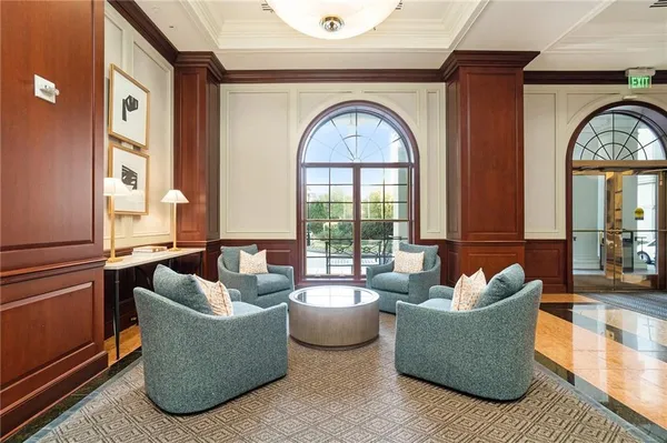 a living room with fireplace furniture and a large window