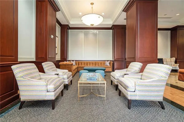 a living room with furniture a lamp and a chandelier