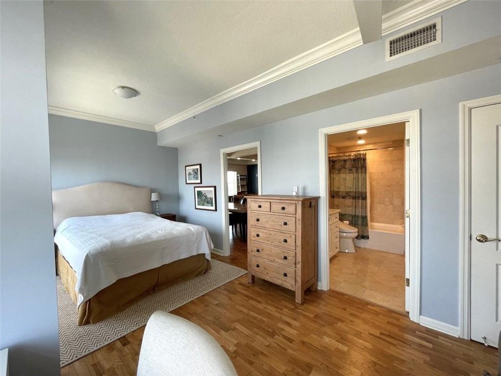 195 14th Street Northeast, Unit P603 Atlanta, GA 30309 - Photo 4 of 27 a bedroom with a bed and a dresser