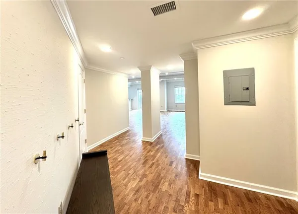 a view of a hallway with wooden floor