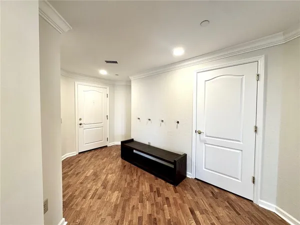 a view of a room with wooden floor and window