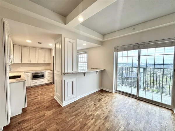 a view of a kitchen with a stove top oven