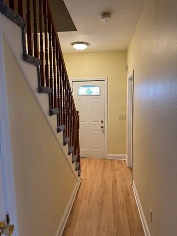 a view of hallway with wooden floor