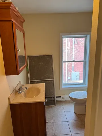a bathroom with a sink toilet and mirror