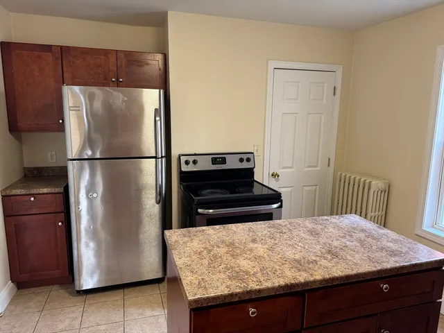 a kitchen with a refrigerator and a stove