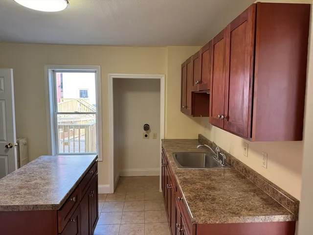 a kitchen with a sink a stove and cabinets