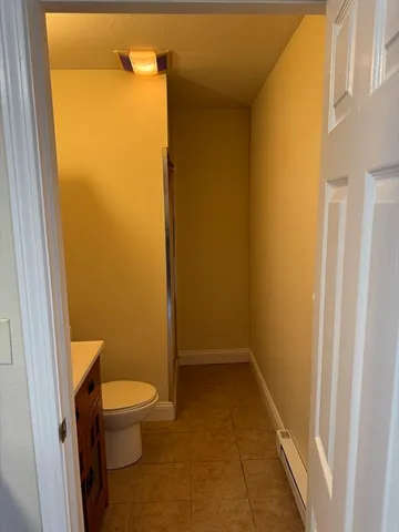 a bathroom with a toilet and a shower