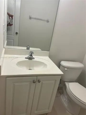 a bathroom with a sink a toilet and mirror