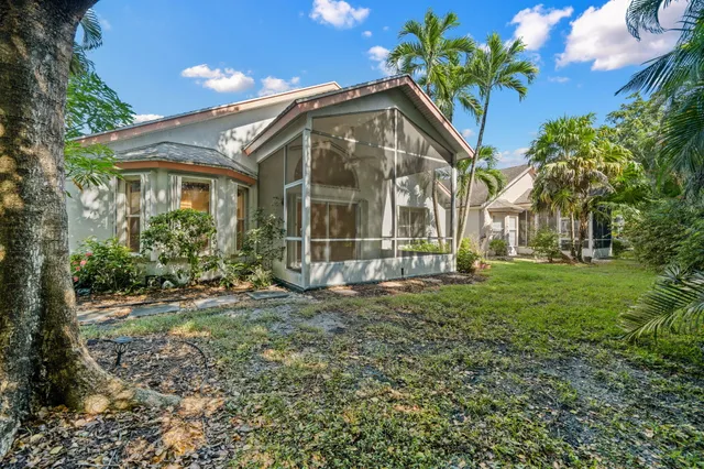 an aerial view of a house with garden space and street view